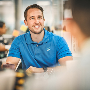 An ADM associate sits at a table talking 