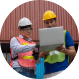 construction workers looking at laptop