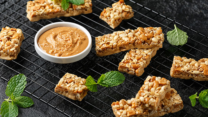 A group of granola bars and peanut butter 