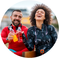 A couple enjoying fruit flavoured red and yellow color drinks in their hands
