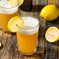our portfolio hop flavors lemon shandy beer like beverage with lemon wedge