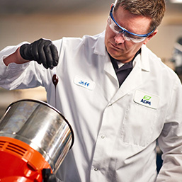 C58 Male scientist in laboratory wearing while lab jacket and safety glasses