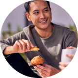 A person eating a muffin